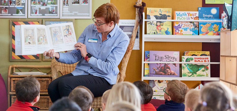 Image of teacher reading to students